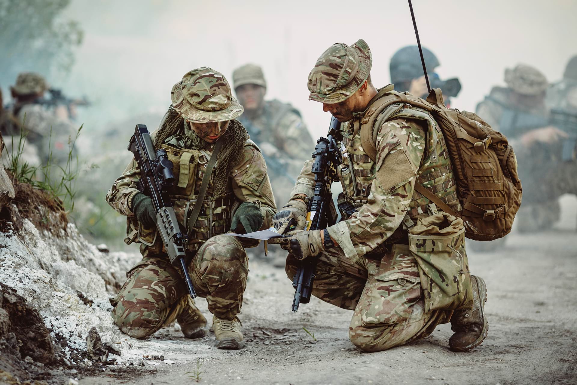 soldiers checking instructions during military training
